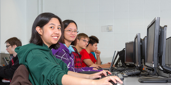 Picture of Centennial College students in a computer lab smiling